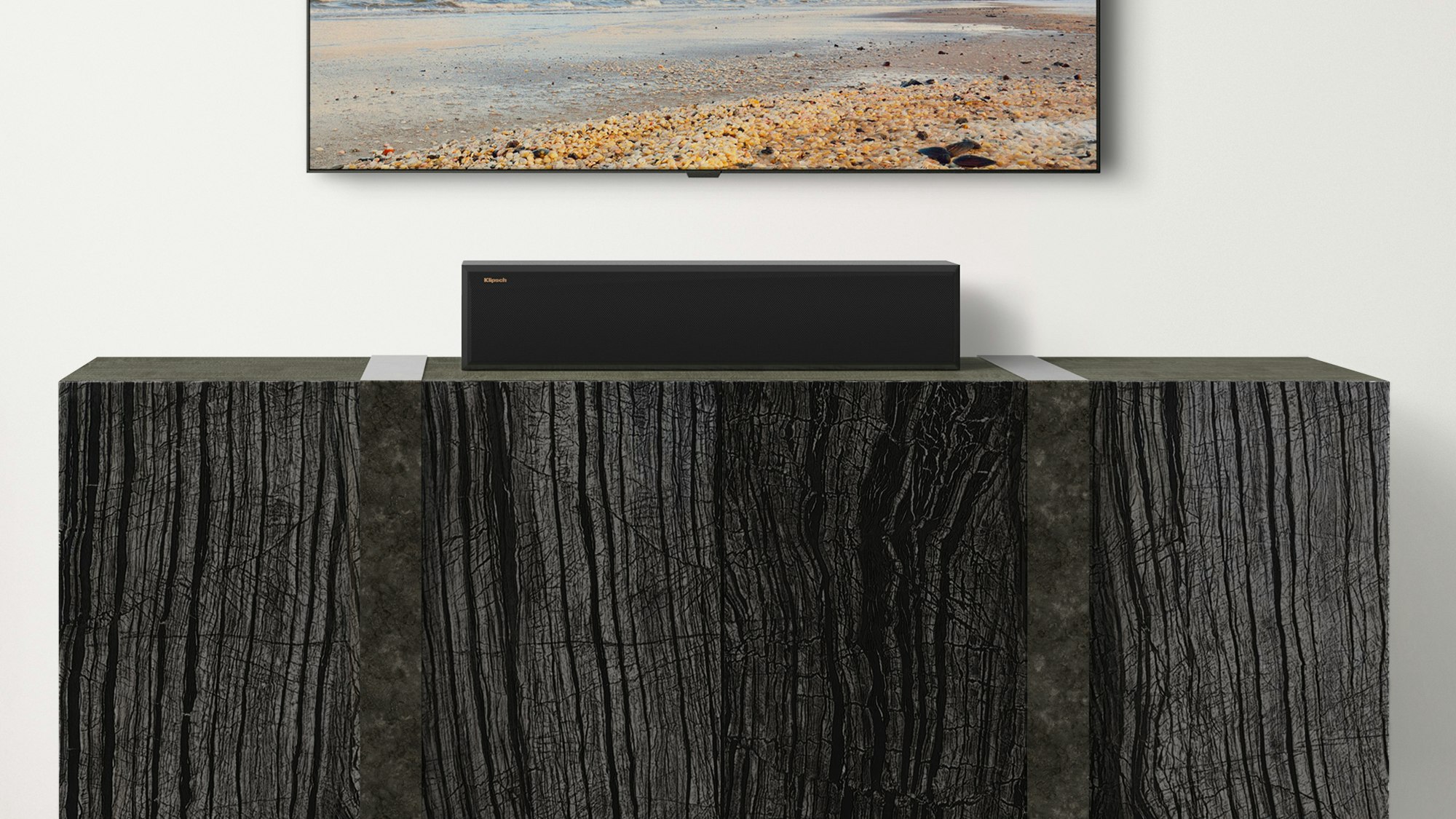 RP 404 C II Center Channel Speaker on a wooden credenza under a TV